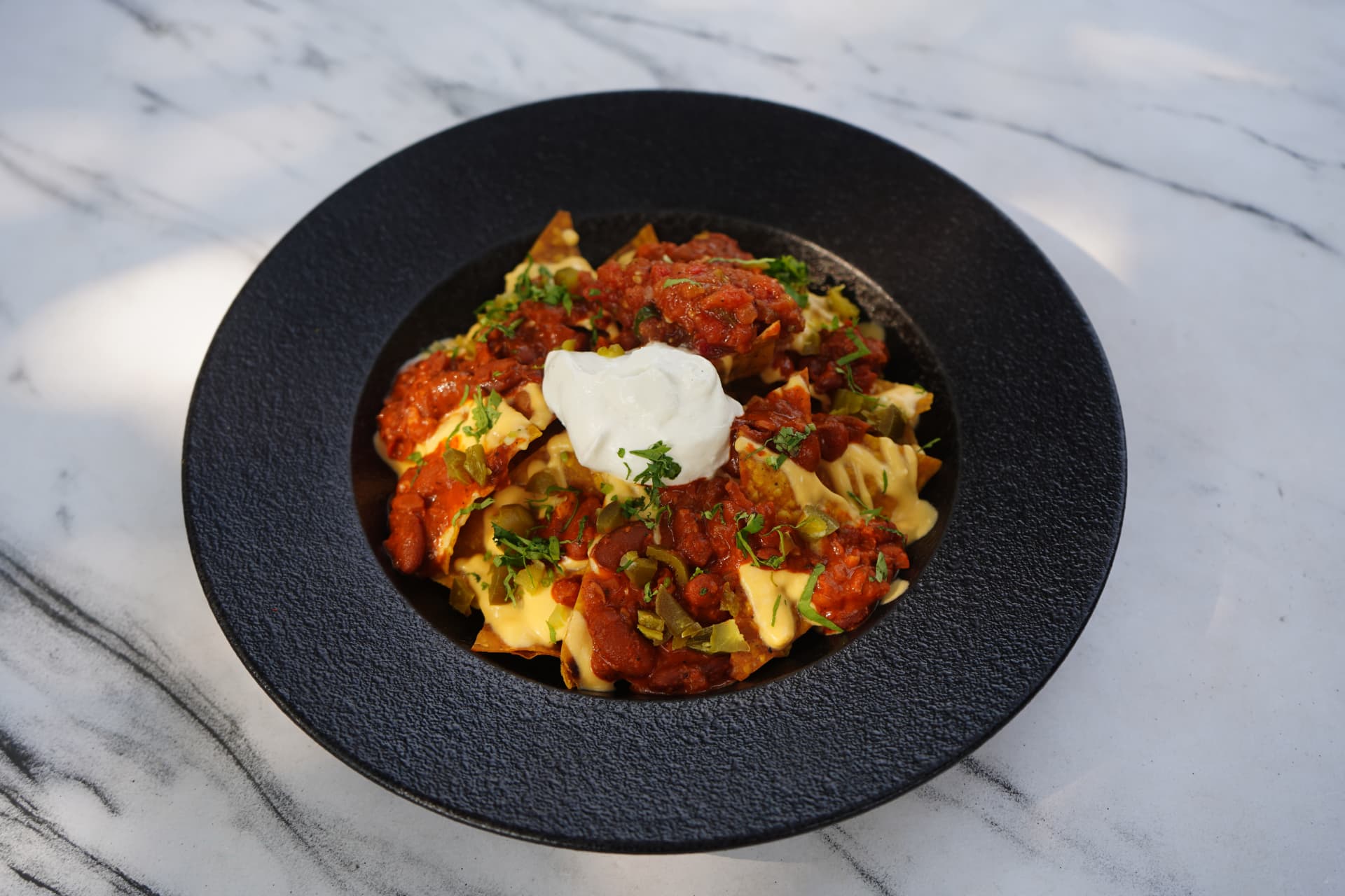 Loaded nachos with salsa, cheese and sour cream