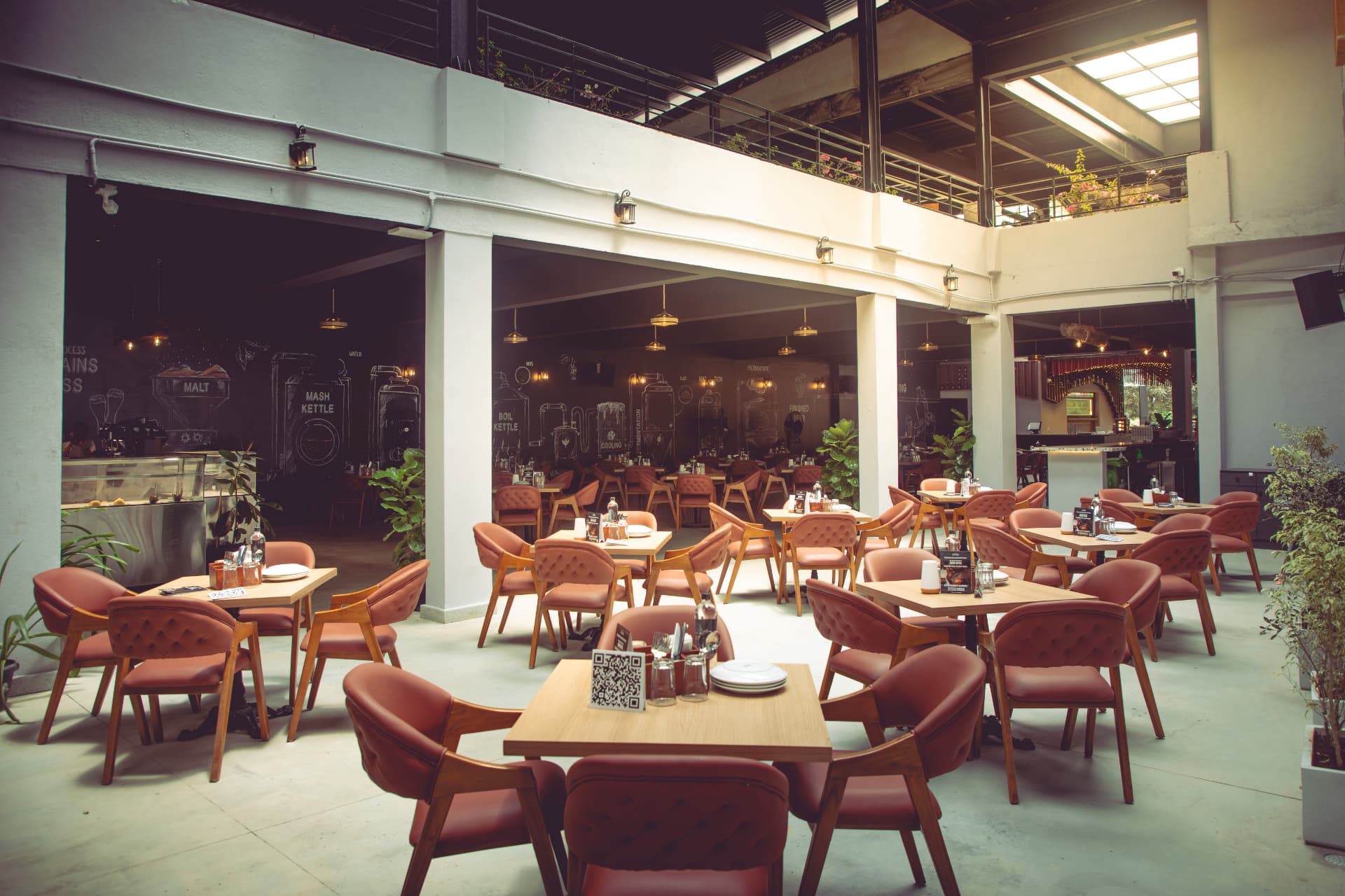 Courtyard dining beside the brewing mural