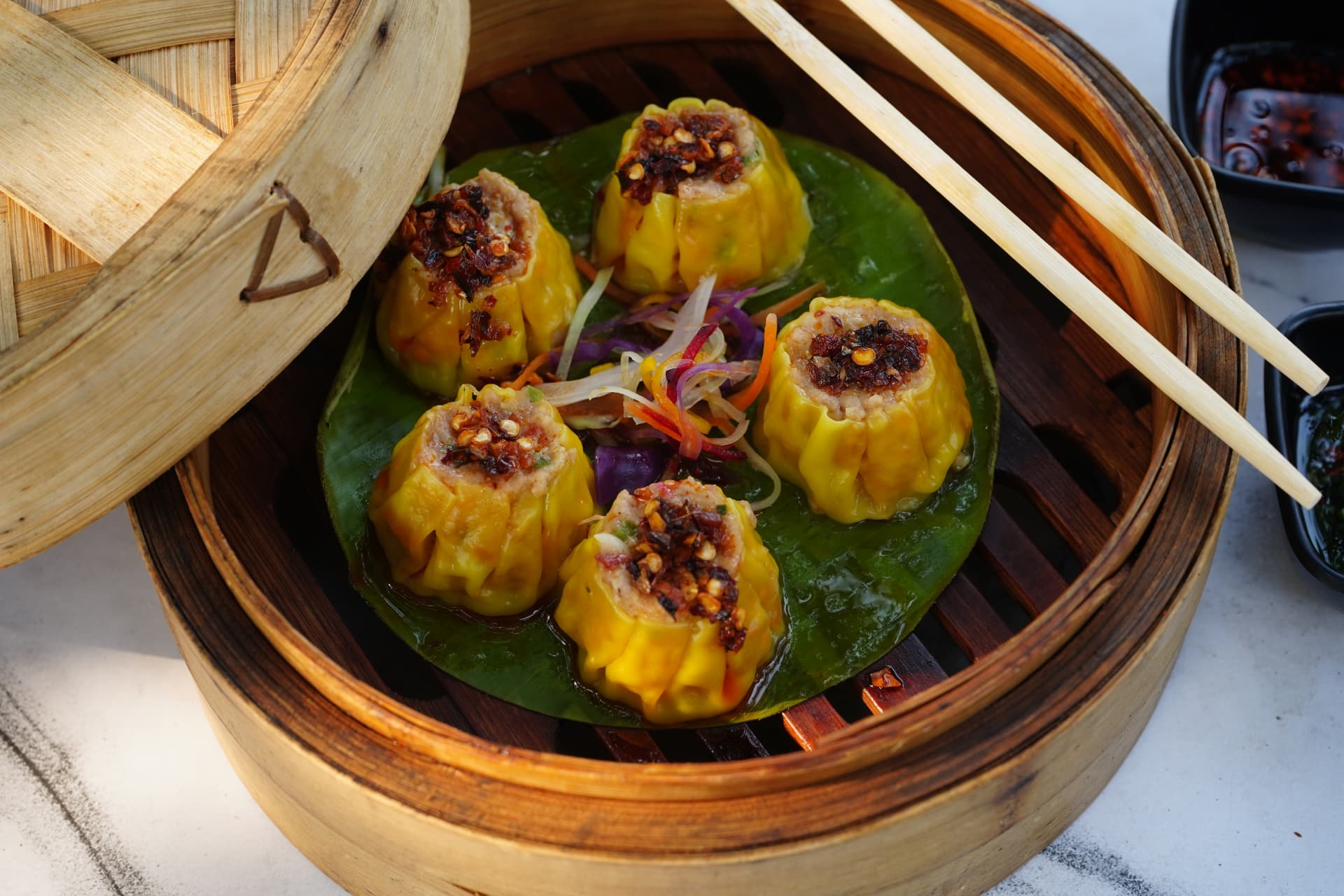 Steamed dim sums topped with chilli garlic crisp