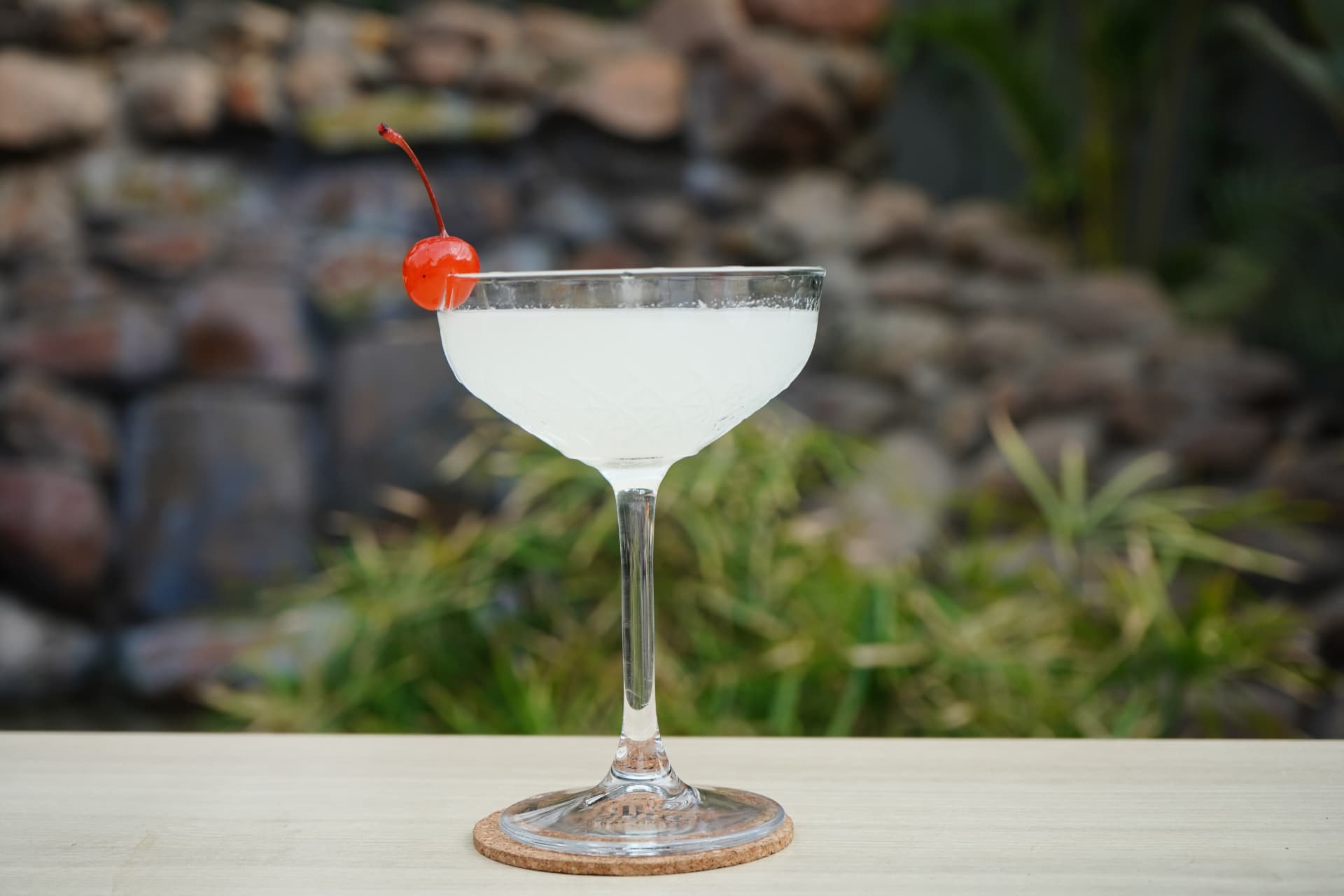 Frosty coupe cocktail garnished with a cherry