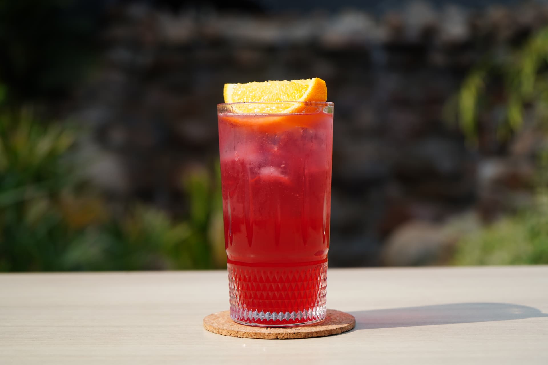 Crimson cocktail with an orange wheel